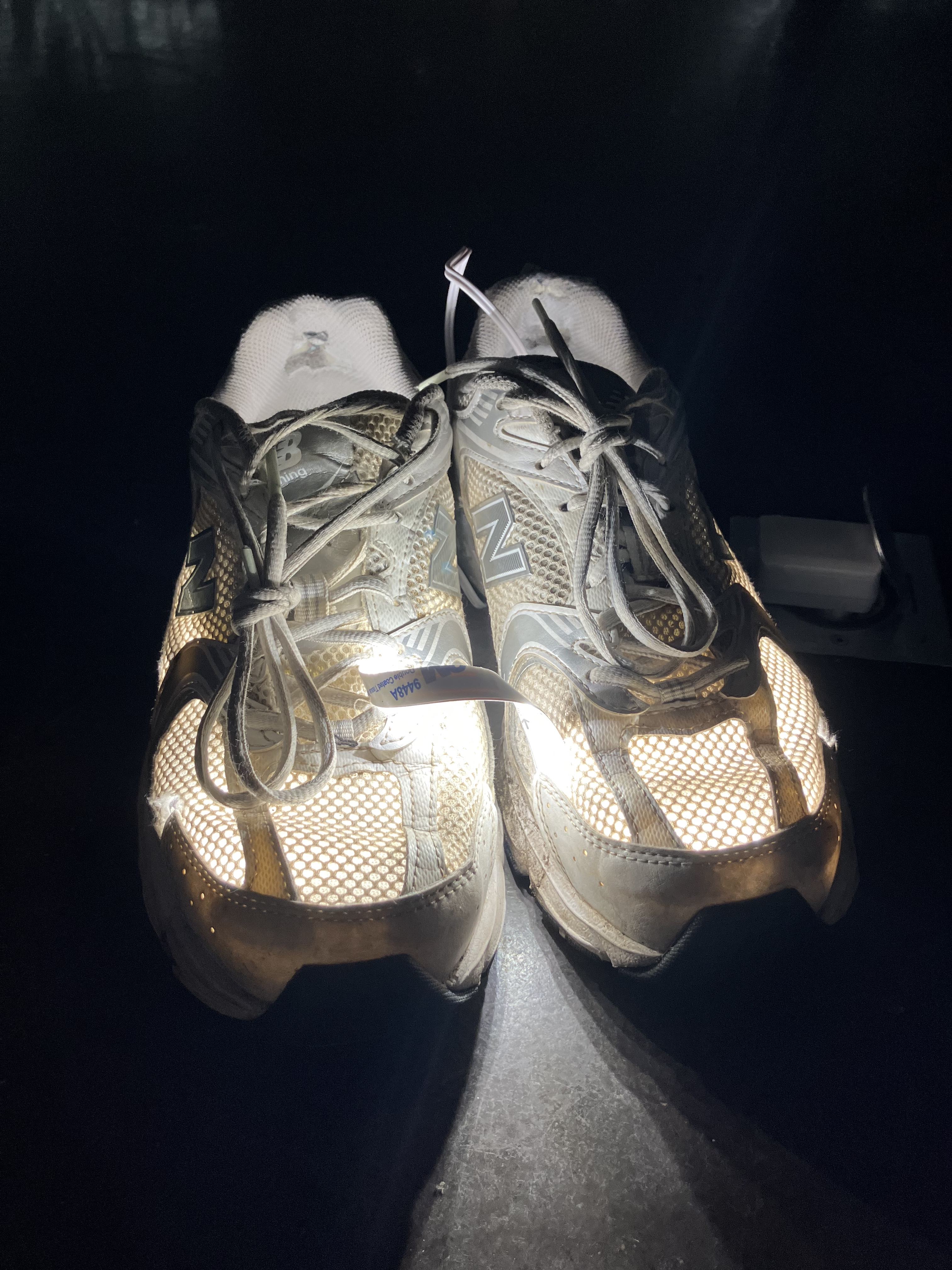 An iphone picture showing a lamp made from a worn pair of New Balance 530 sneakers and white LEDs